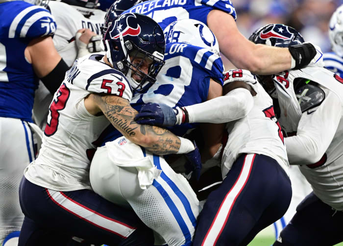 Texans linebacker Blake Cashman grimaces as he helps to tackle Indianapolis Colts running back Jonathan Taylor (28) during the second half at Lucas Oil Stadium.